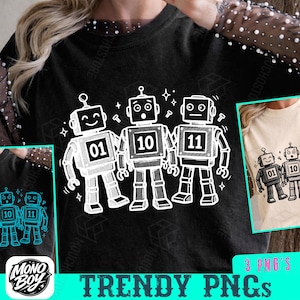 Peut inclure: Sweatshirt noir avec un motif blanc de trois robots portant les numéros 01, 10 et 11. Les robots sont entourés d'étoiles et d'éclairs. Le texte "TRENDY PNGs" est en bas de l'image. Un logo est également présent.