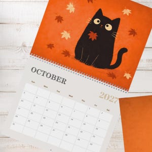 Cute cat calendar 2027 with monthly planning pages and charming black cat artwork, designed for organizing appointments and special events.