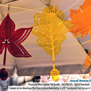 May include: Three layered leaf wind spinners in red, yellow, and orange. The leaves are cut from translucent acrylic and hang from a ceiling. The text "Three Leaf Wind Spinner File Bundle - SVG PNG EPS - Digital Download - No Product Shipped" is at the bottom of the image.