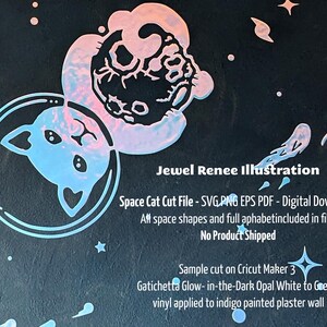 Vector art cut file design of Cat in bubble space helmet hugging astronaut surrounded by galaxy of stars. Cut from gatichetta glow-in-the-dark opal white to green vinyl. shown on dark blue painted wall.  Listing is for Cut File, Immediate download