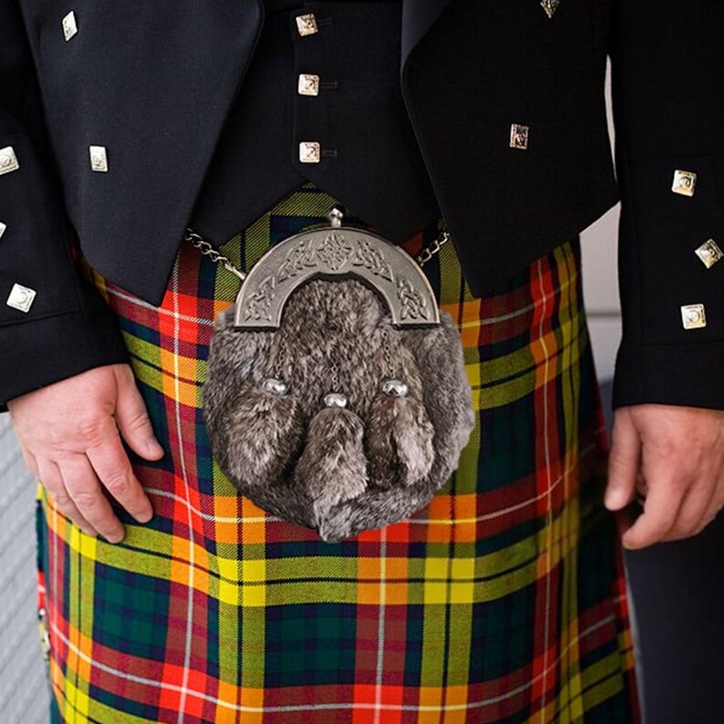 Rabbit fur Scottish sporran with chrome Celtic detail worn over a tartan kilt.