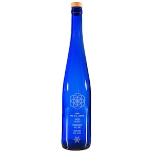 May include: A blue glass bottle with a wooden cork top. The bottle has a white geometric design and text that reads "AMOR 880.412.1230812 SALUD 310.122.1 ABUNDANCIA 310.100.1 GRATITUD 514.1123"