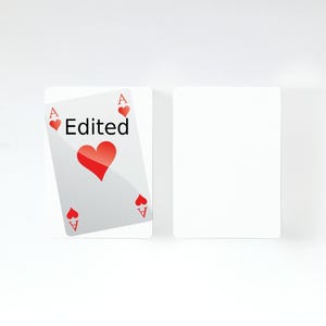 May include: Two rectangular playing cards. One card features the letter A and a red heart symbol in the corners, with the word Edited printed in black text above a large central red heart. The second card is entirely blank and white.