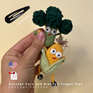 May include: Two small crocheted vegetable figures, a dark green broccoli and a yellow corn cob, both featuring white eyes with black pupils and red stitched mouths. The corn has light green husks and thin legs with black feet. Text reads Crochet Corn and Broccoli Fidget Toys.