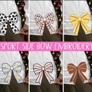May include: White sweatshirt featuring embroidered sports-themed bows. Designs include a football, basketball, baseball, and softball. The text "SPORT SIDE BOW EMBROIDERY" is displayed in pink.