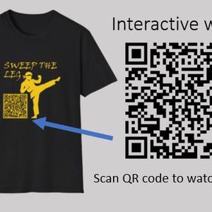 May include: Black t-shirt with a yellow graphic of a martial artist kicking, the words "SWEEP THE LEG", and a QR code. The text "Interactive wear" and "Scan QR code to watch Video" are also present.