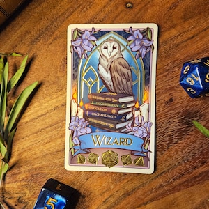 May include: A card with a blue and gold design featuring a white owl perched on a stack of books. The card says "Wizard" and has a banner with the words "Abjuration", "Necromancy", "Evocation", "Enchantment", and "Conjuration".