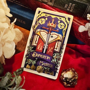 May include: A fantasy-themed card with a crown, sword, and open book design. The card features the text "DUNGEON MASTER" on a purple banner. Gold accents and dice are also visible.