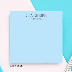 May include: A baby blue notepad with the text "CLAIRE KIRK PRINCIPAL" at the top. The words "BABY BLUE" are at the bottom. A blue highlighter and a white pen are in the background.