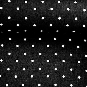 May include: Black fabric with a white polka dot pattern. The fabric is folded in half, showing the pattern on both sides.