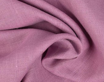 May include: A close-up of a soft, textured fabric in a dusty rose color. The fabric is folded and draped, showing its natural wrinkles and texture.
