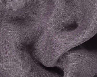 May include: A close-up of a soft, textured, gray fabric. The fabric has a subtle sheen and a slightly wrinkled appearance.