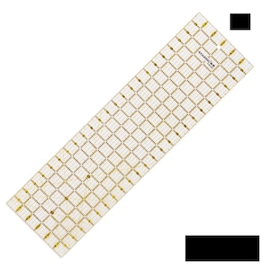 May include: A clear, rectangular quilting ruler with a grid pattern and measurement markings. The ruler is made of transparent material with gold-colored markings. The brand name "Kearing" is printed on the ruler.