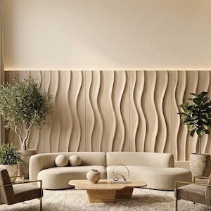 May include: A curved beige sofa sits before a wall with vertical light wood wave panels. Two gray armchairs with gold frames flank a low, irregular wood coffee table. Two potted green trees stand on either side of the sofa on a textured rug.