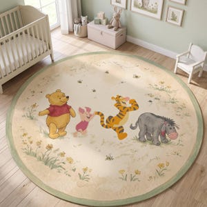 May include: A round area rug featuring a cream-colored background with a green border. The rug displays illustrations of Winnie the Pooh, Piglet, Tigger, and Eeyore walking in a line, surrounded by small yellow flowers, green grass, and bees.