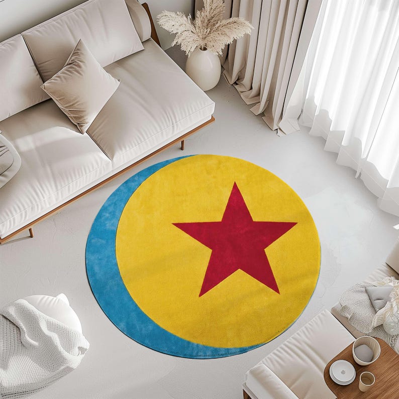 a living room with a large, colorful rug on the floor. The rug has a yellow and blue design with a red star in the center. The room also includes a white couch, a coffee table, and a potted plant.