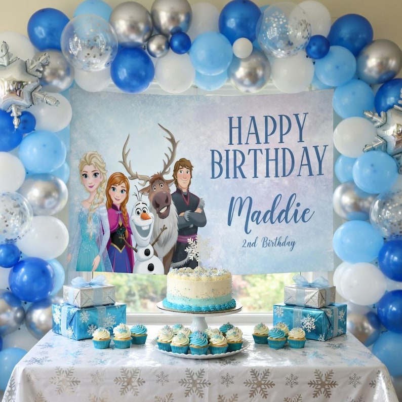May include: A birthday party scene with a banner that reads "Happy Birthday Maddie 2nd Birthday." The scene includes blue, silver, and white balloons, a cake, cupcakes, and wrapped gifts. The banner features characters from the movie Frozen.