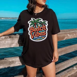 May include: Black t-shirt with a colorful graphic of palm trees and the text "Beach Vibes".