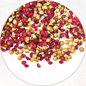 May include: A close-up image of red and gold rhinestones. The gems are scattered, with a mix of red and gold tones. The rhinestones are faceted, reflecting light. Suitable for various craft projects, including nail art and jewellery making.
