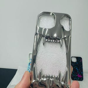 3D Hollow Fanged Skull iPhone Case – Metallic Silver & Black Creative Protective Cover for Gothic and Punk Style image 3