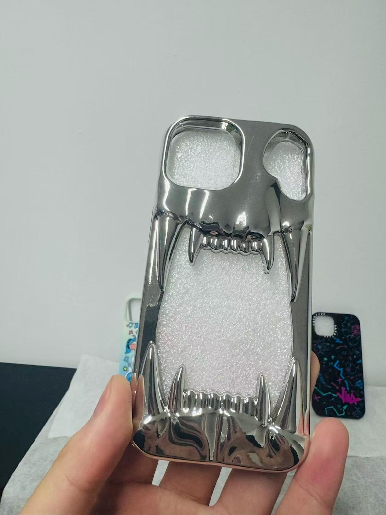 3D Hollow Fanged Skull iPhone Case – Metallic Silver & Black Creative Protective Cover for Gothic and Punk Style image 3