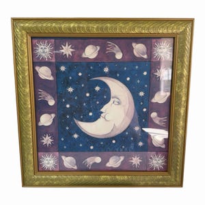 May include: A square framed wall art piece featuring a central crescent moon with a human face set against a dark blue starry background. The border consists of purple panels decorated with illustrations of suns, stars, planets, and comets.