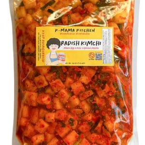 May include: A set of three ceramic mugs with a speckled, matte finish. The mugs are in shades of cream, light gray, and dark gray. Each mug has a simple, minimalist design and a rounded handle.