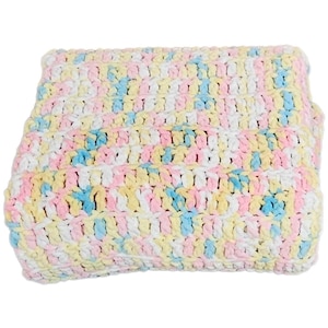May include: A folded, pastel-colored crochet blanket. The blanket features a repeating pattern of white, yellow, pink, and blue yarn. The texture appears soft and plush, suitable for a baby or child.