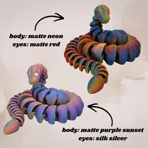 May include: Two articulated snake toys. One has a matte neon body and matte red eyes. The other has a matte purple sunset body and silk silver eyes. The toys are colorful and have a segmented design.