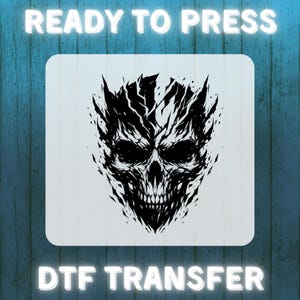 May include: A black and white graphic of a skull with sharp, jagged edges, printed on a light-colored square. The words "READY TO PRESS" and "DTF TRANSFER" are in white, glowing text above and below the skull design.