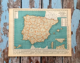 May include: A vintage map of the Iberian Peninsula, including Spain and Portugal, with a teal background and orange-brown borders. The map is from the Rand McNally World Atlas and Gazetteer.