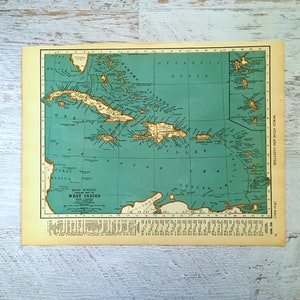 May include: A vintage map of the West Indies, showing the islands of Cuba, Jamaica, Puerto Rico, and Hispaniola. The map is printed on a light blue background with brown lines and text. The title "West Indies" is printed in bold at the bottom of the map.