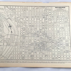 May include: A vintage map of Philadelphia, Pennsylvania, with detailed street layouts and landmarks. The map includes text that reads "Philadelphia" and "Cities and Towns of the World". The map is printed in black ink on aged paper.