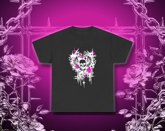 May include: A black short-sleeve t-shirt featuring a central graphic print of a skull with wings, surrounded by white and pink starbursts, swirls, and heart shapes. The design is centered on the chest of the garment against a solid black fabric.