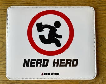 May include: A rectangular white mouse pad featuring a red circular border surrounding a black silhouette of a person running with a briefcase. Below the graphic, the text reads NERD HERD in black, followed by a small icon and FLEXI ARCADE.