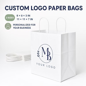 May include: A white paper bag with twisted handles featuring a dark blue circular logo with the letters MB and a leaf design. Text reads CUSTOM LOGO PAPER BAGS, 2 SIZES 6 x 8 x 3 IN and 11 x 11 x 7 IN, and PERSONALIZED FOR YOUR BUSINESS.
