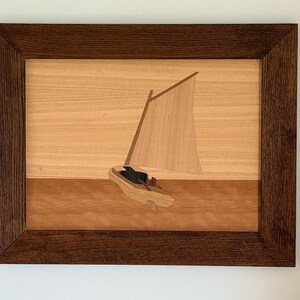 Sailing dinghy with gaff rig in exotic hardwood veneers.