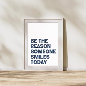 Könnte beinhalten: Ein weißer gerahmter Druck mit dem Text "BE THE REASON SOMEONE SMILES TODAY" in blauer Schrift.