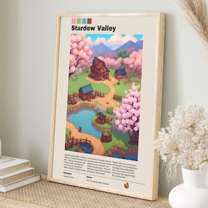 May include: A poster with a light brown wooden frame featuring a colorful illustration of a town called Stardew Valley. The illustration depicts a small town with houses, a pond, and cherry blossom trees. The text "Stardew Valley" is at the top of the poster in a brown font.