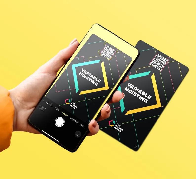 May include: Two black cards with a yellow and turquoise design. The cards have a QR code and the text "VARIABLE HOISTING" and "THE CODING CARDS".