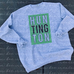 May include: A gray sweatshirt with a green and black graphic that says "HUNTINGTON" on the front.