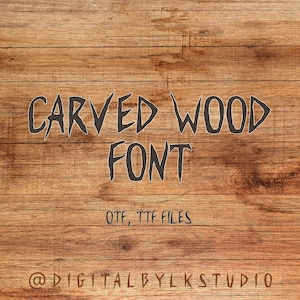 May include: A digital graphic with the words "CARVED WOOD FONT" in a dark gray, stylized font. Below the font, the text reads "OTF, TTF FILES". The background is a light brown wood grain.