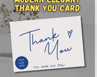 May include: A simple thank you card with a blue handwritten "Thank You" and a heart. The card has a space for a logo and the text "You made our Day!"  @DIGITALBYLKSTUDIO is printed at the bottom.