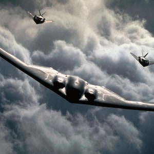 May include: A formation of stealth bomber aircraft flying through a cloudy sky. The lead aircraft is a large, dark gray B-2 Spirit bomber, with two smaller aircraft in the background. The sky is filled with dark, ominous clouds.
