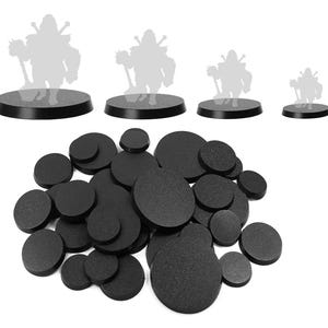 May include: A collection of black, round miniature bases in various sizes, with a textured surface. Silhouettes of figures stand on some of the bases. The bases are designed for tabletop gaming miniatures.