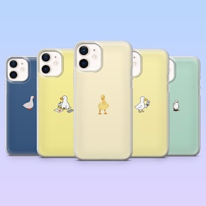 May include: Five mobile phone cases in various colours, each featuring a different duck illustration. The cases are in shades of blue, yellow, and green. Designs include a duck with a flower and a duck with a calculator.