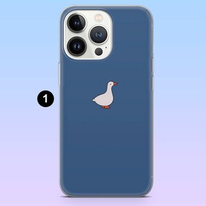 May include: A navy blue phone case with a cartoon goose design. The white goose has orange feet and a red beak. The case has a clear border and is designed for a smartphone with multiple camera lenses.