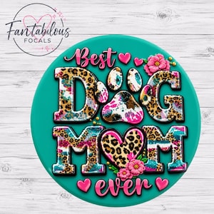 May include: A circular teal graphic featuring the text Best Dog Mom Ever in a leopard print pattern with pink accents. The design includes a central paw print, small pink hearts, and pink flowers surrounding the lettering on a solid teal background.