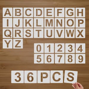 May include: A set of 36 white plastic stencils featuring the alphabet letters A-Z and numbers 0-9. The stencils are arranged on a wooden surface. The text "36 PCS" is also visible.