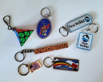 1980s Key Chains - 3D Logic Puzzle, Backpack Zipper Pull, Sea World, Name Key Ring, WV, Cardinal, Rubiks Cube Pyramid, Flag, Rainbow Florida